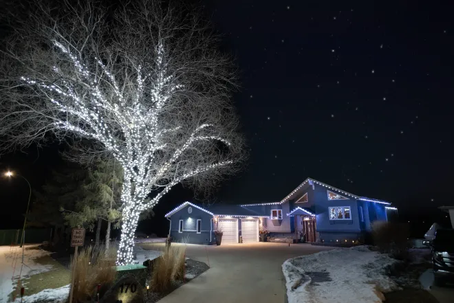 Cool white Christmas lights on the house and a &#039;trunk wrap&#039; in front in West St. Paul, MB
