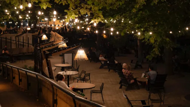 Outdoor festoon lights and custom light fixtures installed at the Fireside Lounge at The Forks, Winnipeg, MB