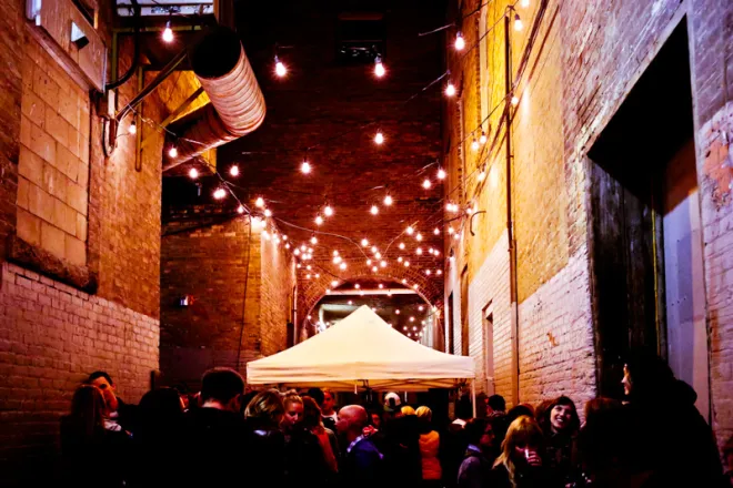 Festoon cafe lights installed for an event in an alley in Winnipeg, MB