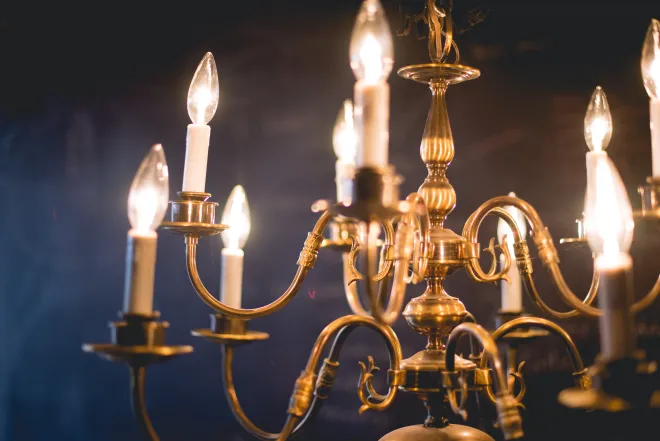 An elegant rental chandelier, lit